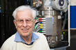 Harald Rose in front of an electron microscope